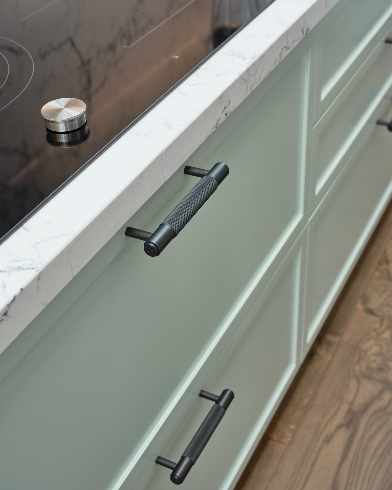 Close detail of a soft-close drawer with a hand-fitted knurled handle on a custom Elite Joinery cabinet.