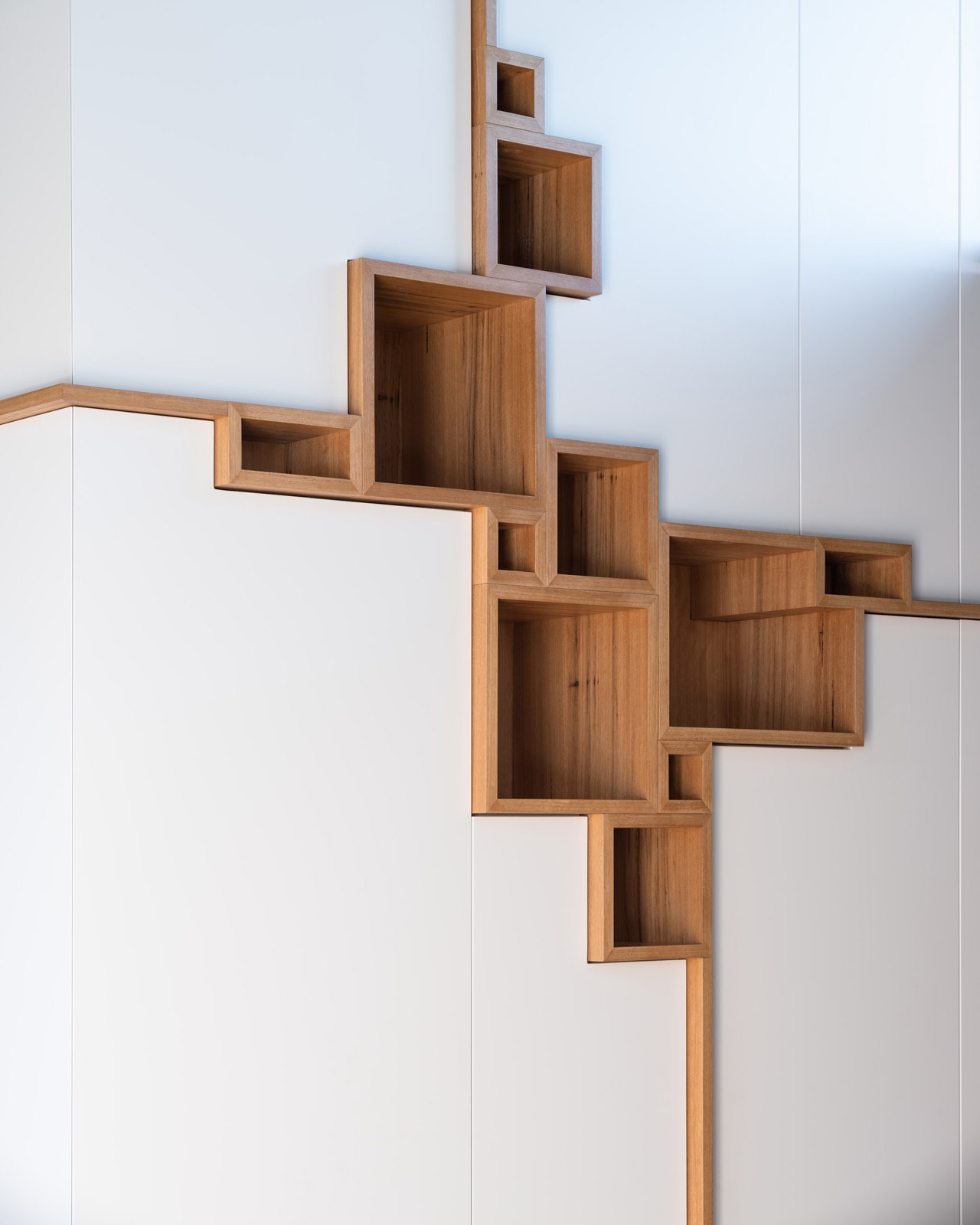 Built-in joinery detail — timber display boxes set into a white cabinetry wall.